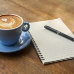 a cup of coffee and a notebook